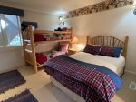 Bedroom Suite 3 with queen bed and log twin over twin bunk bed and flat screen TV